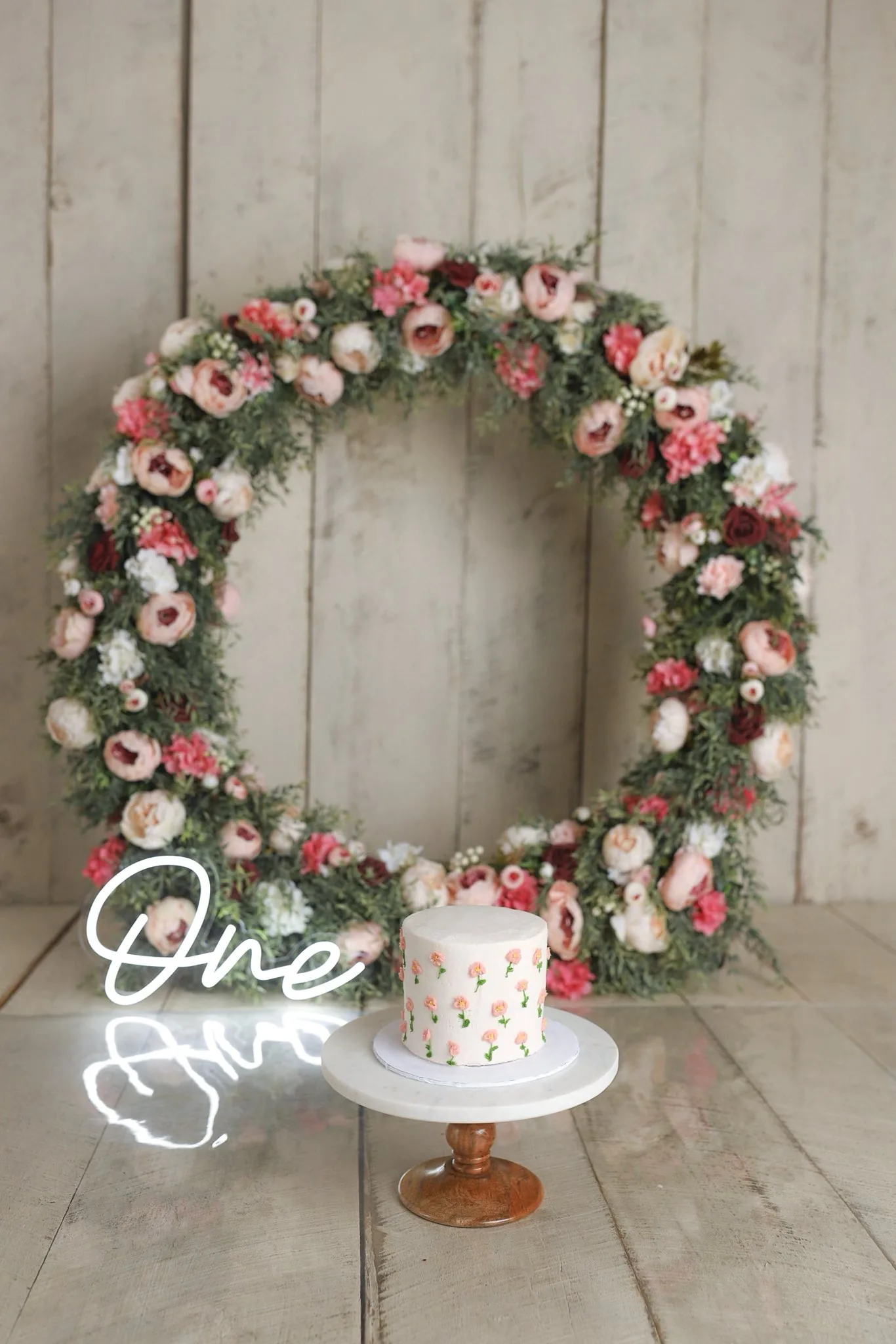 Floral wreath first birthday setup
